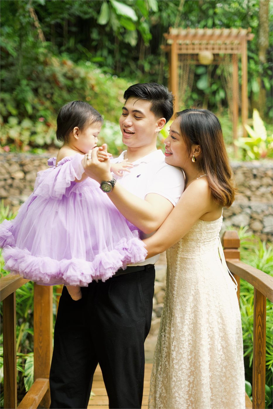 Giana standing between her parents in a garden