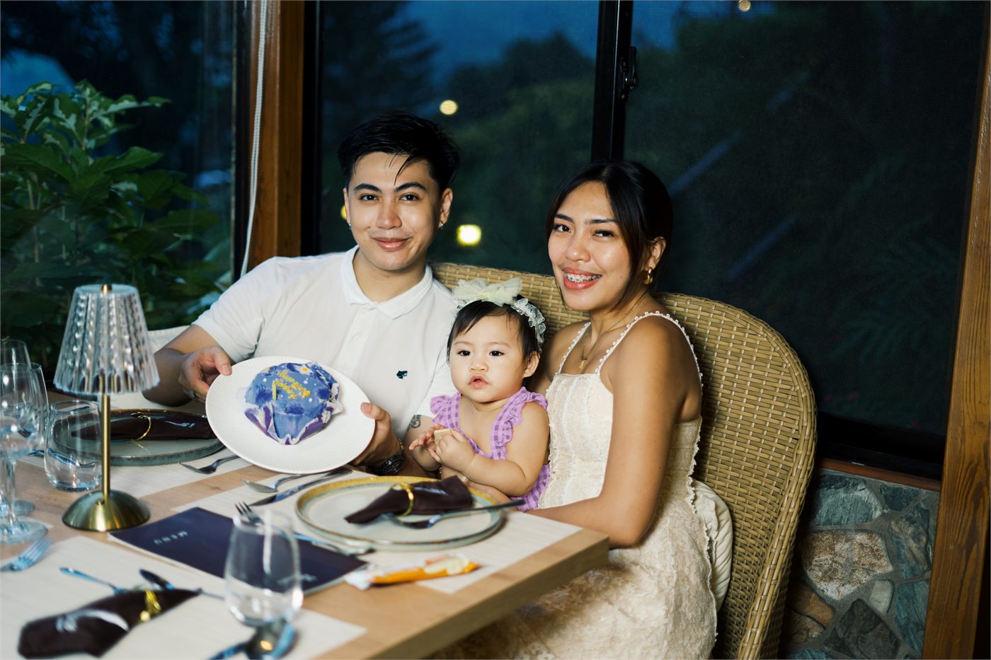 Giana with her parents at a restaurant table