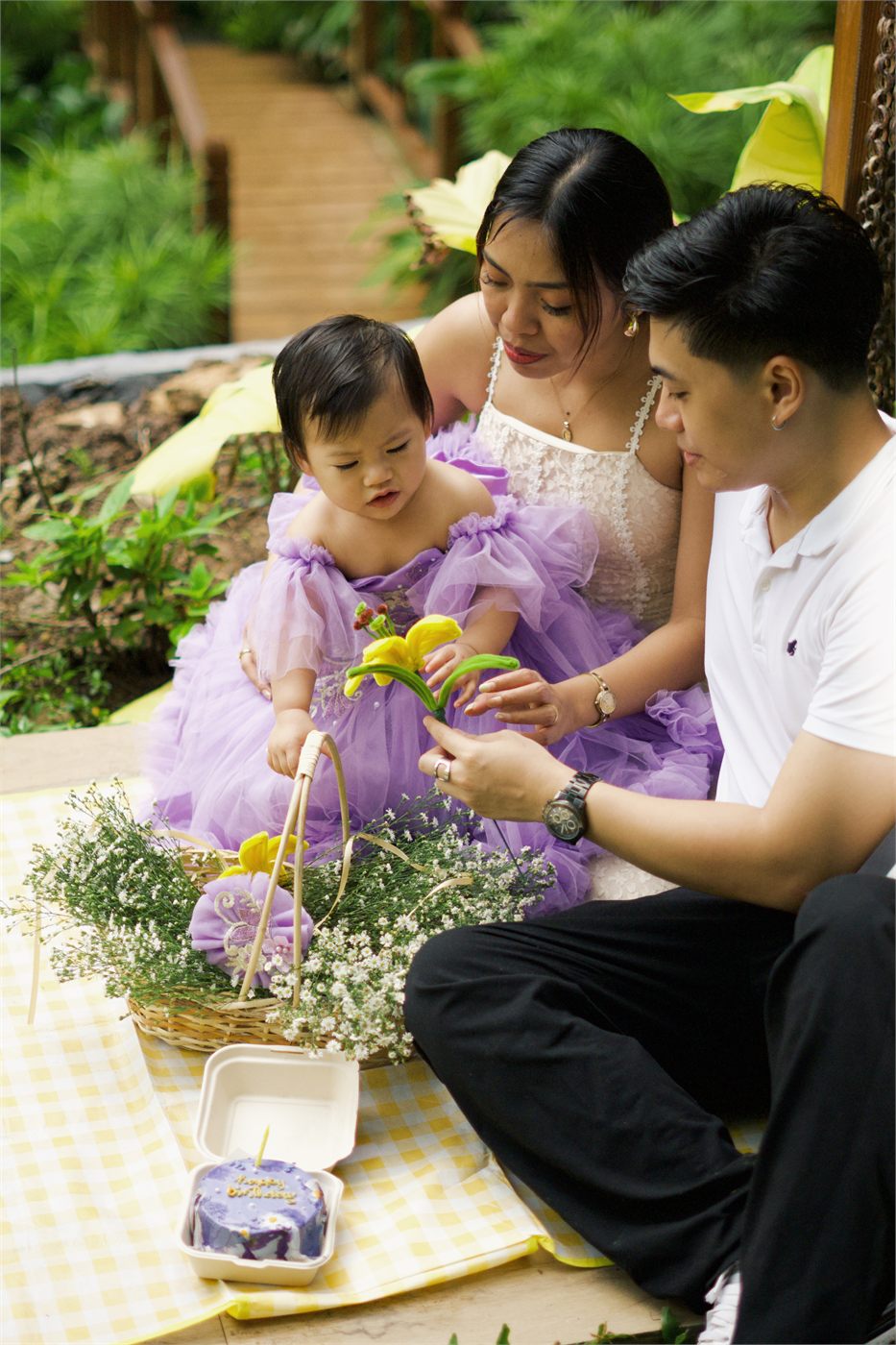 Giana at a garden picnic with her parents
