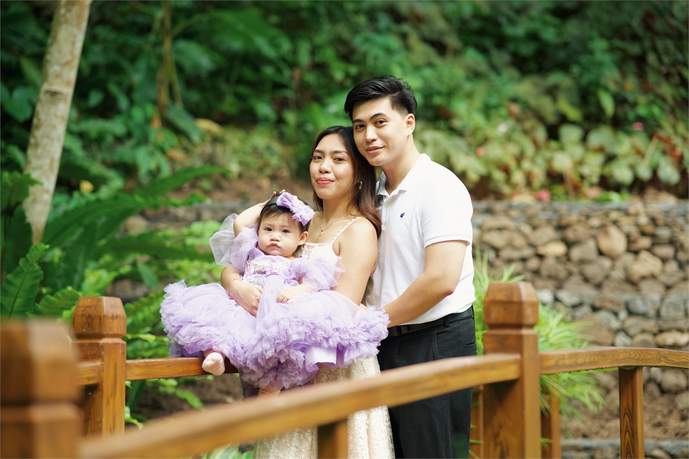 Giana and her parents seated together in the garden
