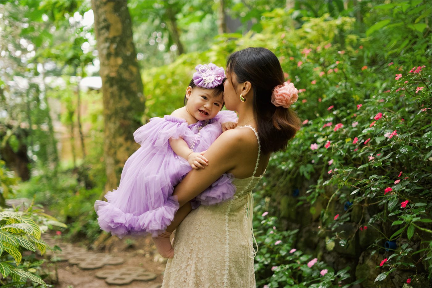 Giana cuddling with her mother in the garden